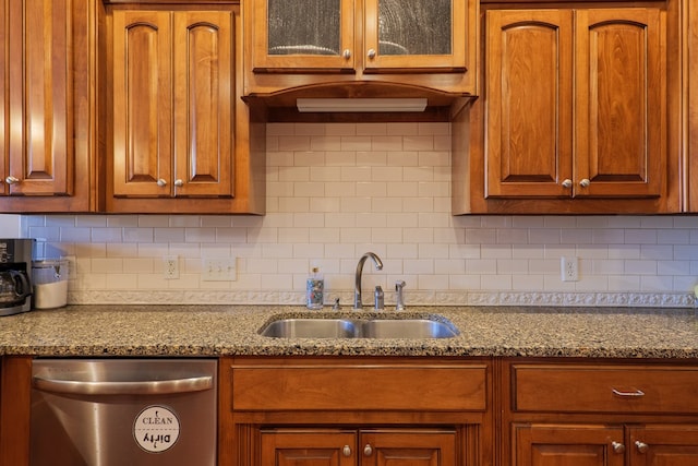 kitchen with light stone counters, sink, backsplash, and dishwasher