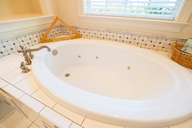 bathroom with tiled bath and a wealth of natural light