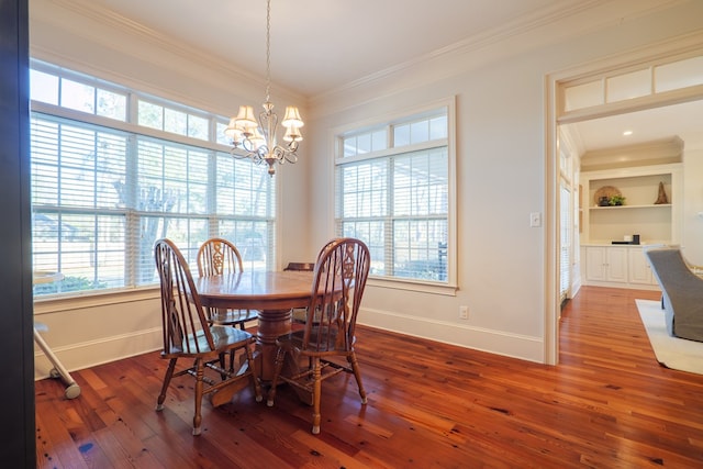 dining space featuring crown molding, hardwood / wood-style floors, and a notable chandelier