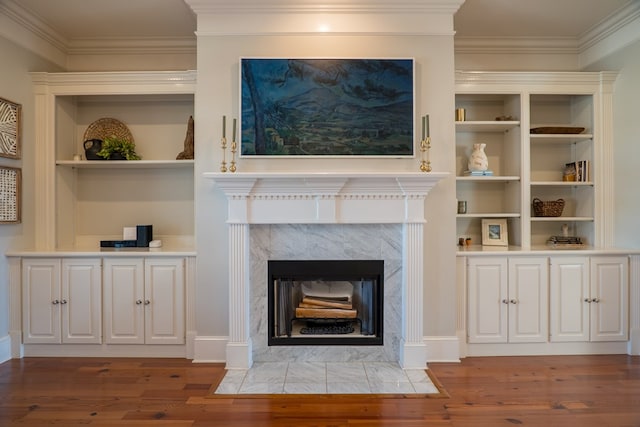 room details with hardwood / wood-style flooring, a high end fireplace, and ornamental molding