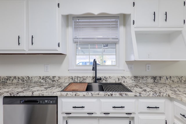 kitchen featuring dishwasher, white cabinetry, light stone countertops, and sink