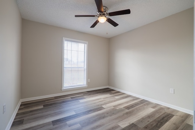 spare room with ceiling fan, hardwood / wood-style floors, and a textured ceiling