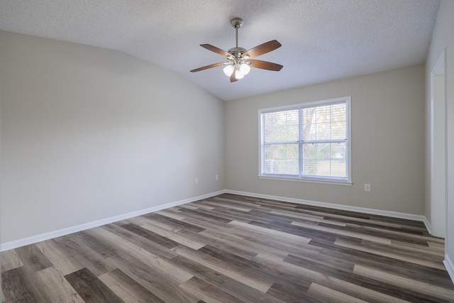 unfurnished room with a textured ceiling, ceiling fan, dark wood-type flooring, and vaulted ceiling