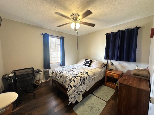 bedroom with ceiling fan, a textured ceiling, and wood finished floors