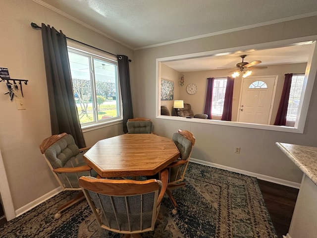 dining space featuring dark wood-type flooring, baseboards, and ornamental molding