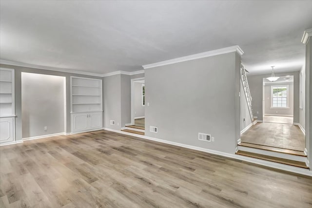 unfurnished living room with crown molding, light hardwood / wood-style flooring, and built in features