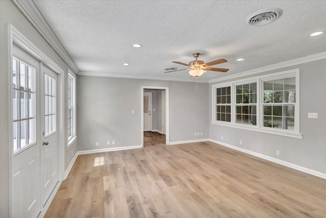 spare room with ceiling fan, light hardwood / wood-style flooring, a textured ceiling, and ornamental molding