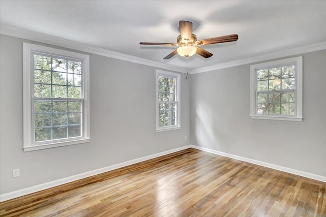 unfurnished room with hardwood / wood-style flooring, crown molding, ceiling fan, and a healthy amount of sunlight