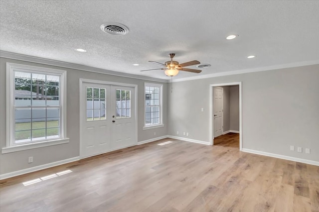 entryway featuring french doors, crown molding, ceiling fan, light wood-type flooring, and a textured ceiling