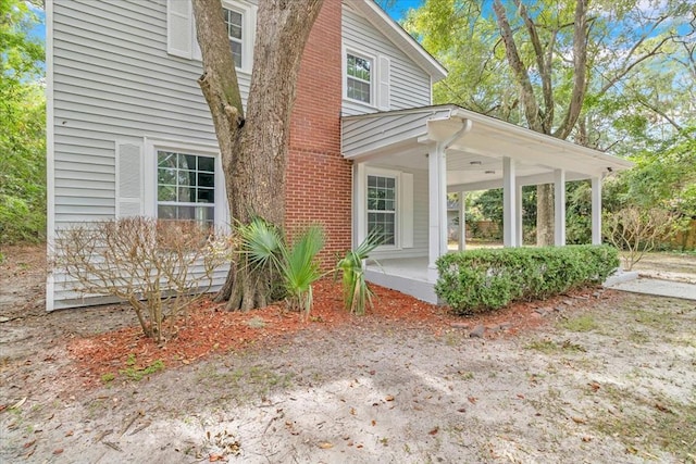 view of property exterior with a porch