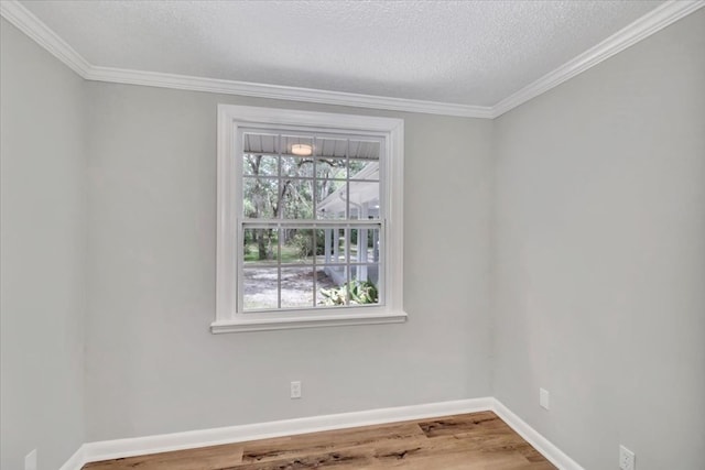 unfurnished room with hardwood / wood-style floors, ornamental molding, and a textured ceiling