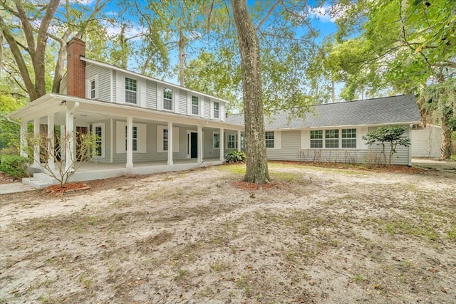 rear view of property with a porch