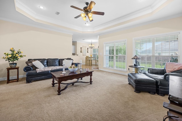 5221 Carys Brook Dr, Hahira, GA 31632 - living area with a raised ceiling, crown molding, light colored carpet, a ceiling fan, and a chandelier