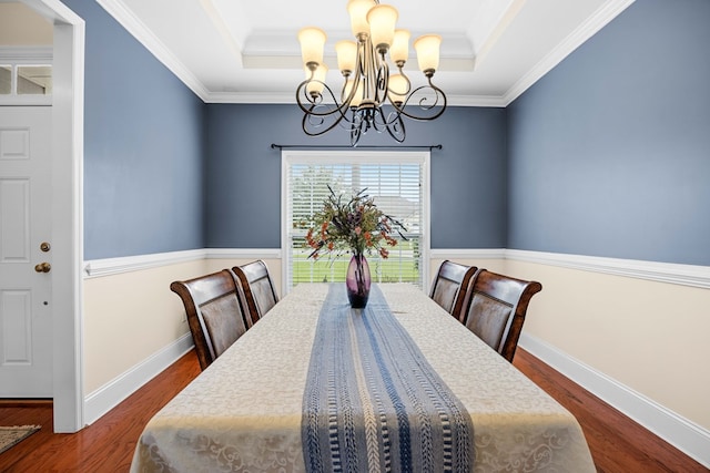 5221 Carys Brook Dr, Hahira, GA 31632 - dining area featuring a raised ceiling, a chandelier, wood finished floors, and ornamental molding