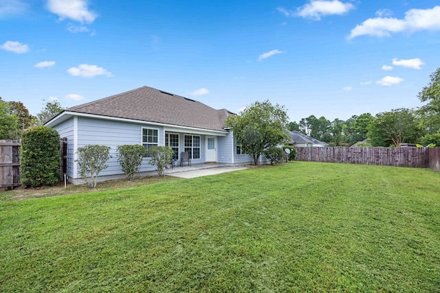 5221 Carys Brook Dr, Hahira, GA 31632 - back of property with a patio area, a fenced backyard, and a shingled roof
