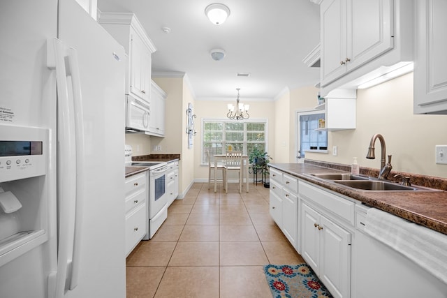 5221 Carys Brook Dr, Hahira, GA 31632 - kitchen featuring white appliances, dark countertops, white cabinetry, a chandelier, and light tile patterned floors