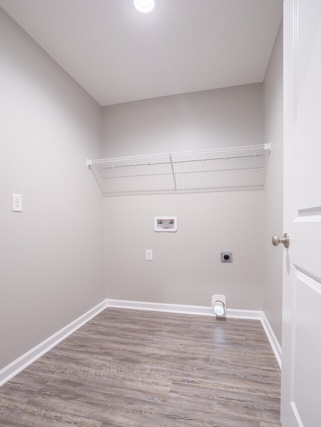 washroom featuring hardwood / wood-style flooring, hookup for a washing machine, and hookup for an electric dryer