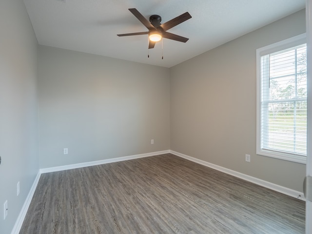 unfurnished room featuring ceiling fan and dark hardwood / wood-style flooring