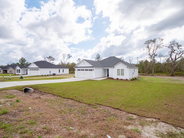 view of front of home featuring a garage and a front lawn