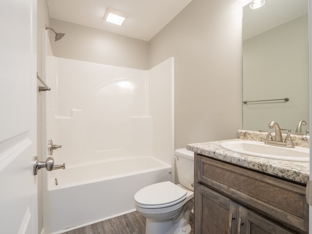 full bathroom featuring hardwood / wood-style flooring, vanity, toilet, and tub / shower combination