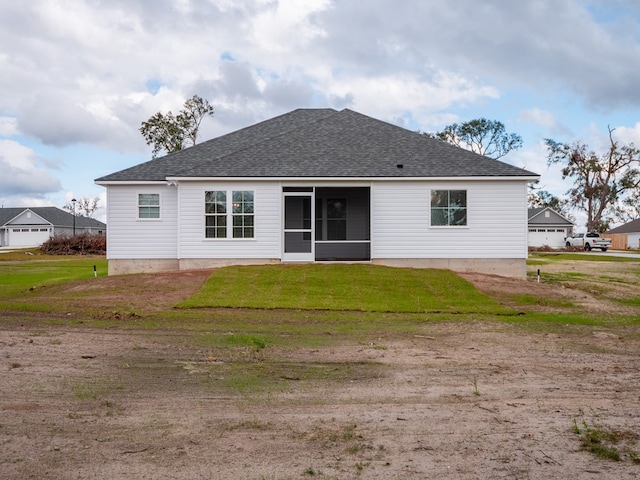 rear view of house with a yard