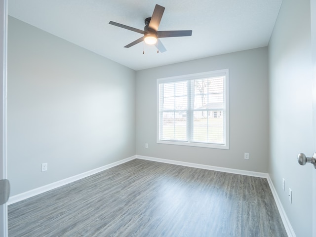 empty room featuring ceiling fan and dark hardwood / wood-style flooring