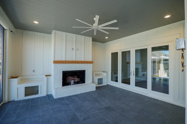 unfurnished living room featuring wood ceiling, ceiling fan, and a fireplace