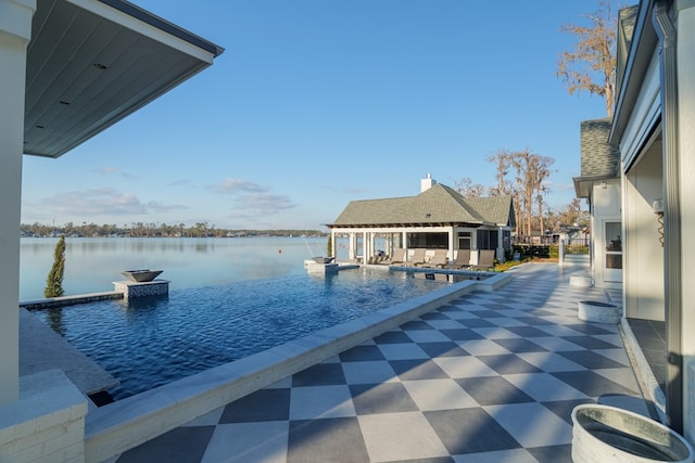 view of swimming pool with a water view