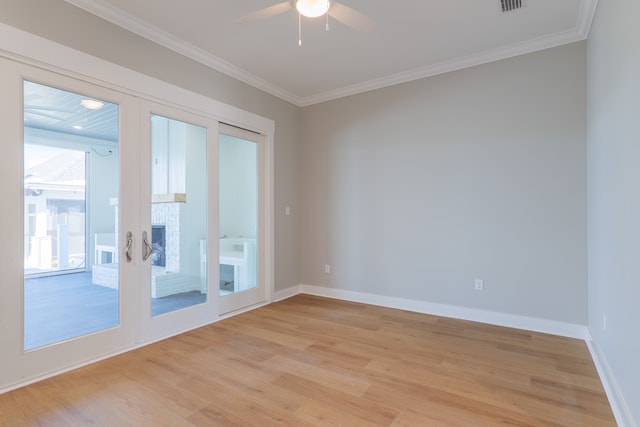 unfurnished room with french doors, ornamental molding, and light hardwood / wood-style flooring