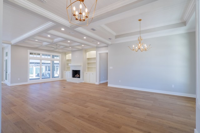 unfurnished living room with an inviting chandelier, crown molding, light hardwood / wood-style flooring, beamed ceiling, and a fireplace