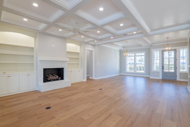 unfurnished living room featuring beamed ceiling, coffered ceiling, and a fireplace