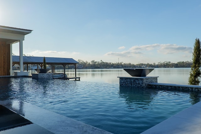 view of pool with a water view and a boat dock