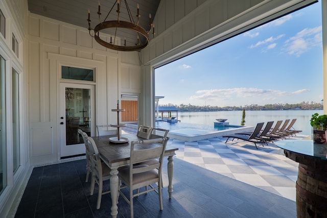 view of patio featuring a jacuzzi and a water view