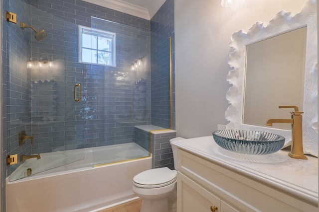 full bathroom featuring bath / shower combo with glass door, vanity, and toilet