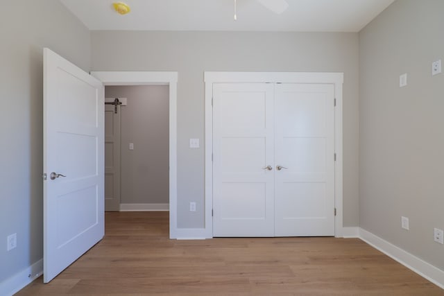 unfurnished bedroom featuring light hardwood / wood-style floors and a closet