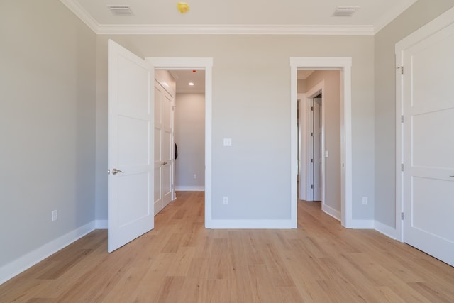 unfurnished bedroom with ornamental molding and light hardwood / wood-style flooring