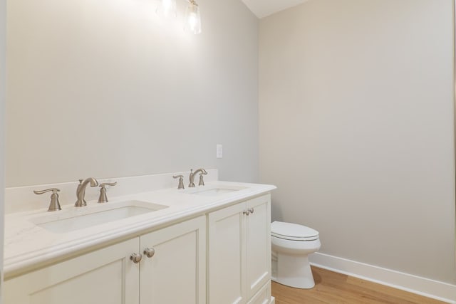 bathroom featuring vanity, hardwood / wood-style floors, and toilet