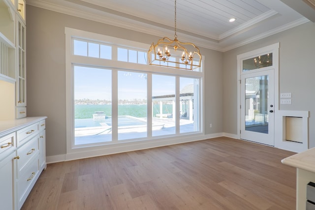 doorway to outside with crown molding, a water view, a notable chandelier, and light hardwood / wood-style flooring