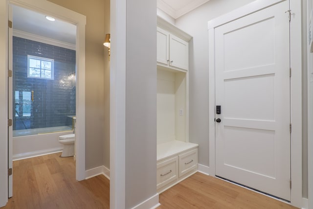 mudroom with crown molding and light hardwood / wood-style floors