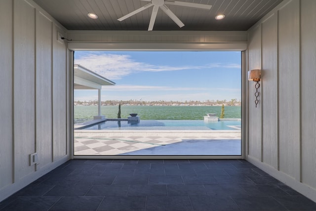 doorway with a water view, a healthy amount of sunlight, and wooden ceiling