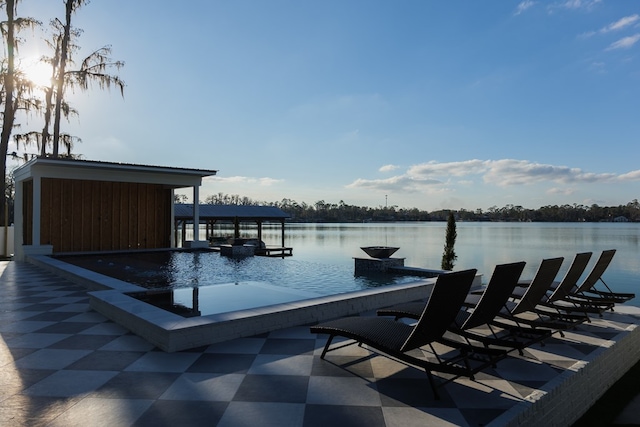 view of swimming pool with a water view