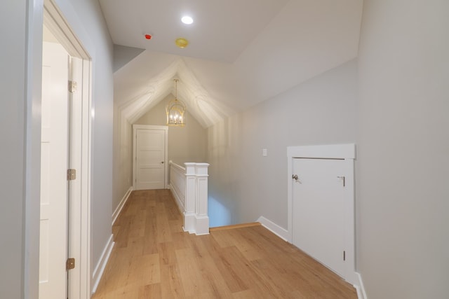 bonus room featuring lofted ceiling and light hardwood / wood-style flooring