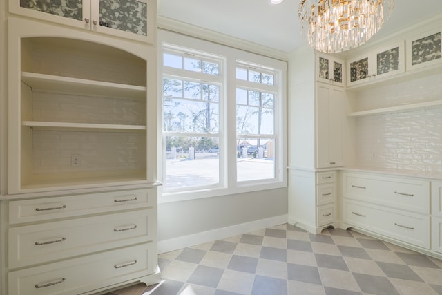 walk in closet featuring a chandelier