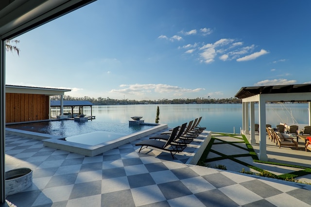 dock area featuring a patio area, a hot tub, and a water view