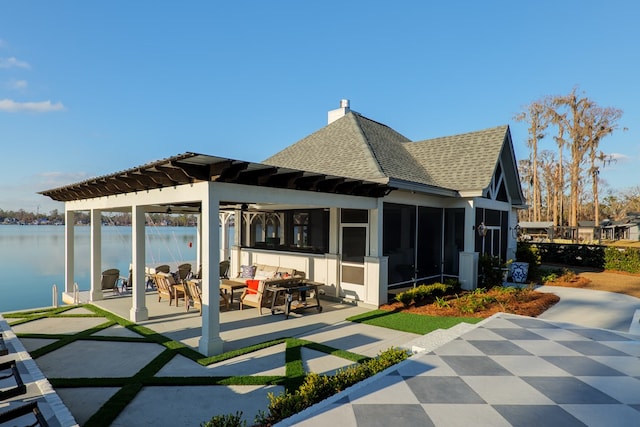 exterior space with a water view, a sunroom, and a patio area