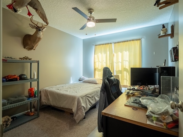 bedroom featuring carpet flooring, a textured ceiling, and a ceiling fan