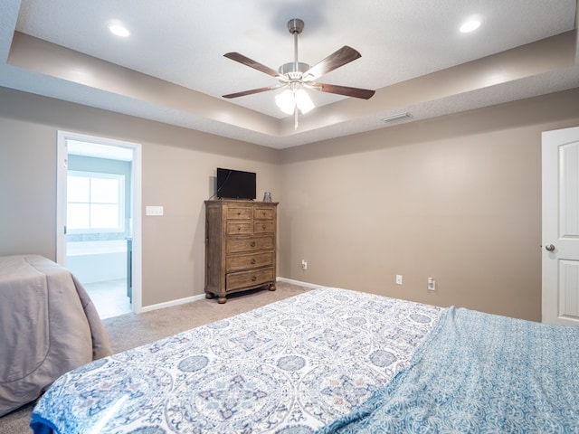 bedroom featuring visible vents, a raised ceiling, recessed lighting, baseboards, and light colored carpet