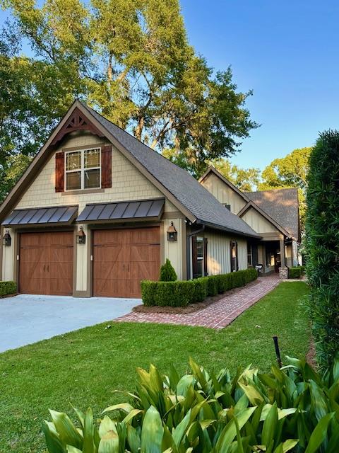 view of front of home with a garage and a front yard