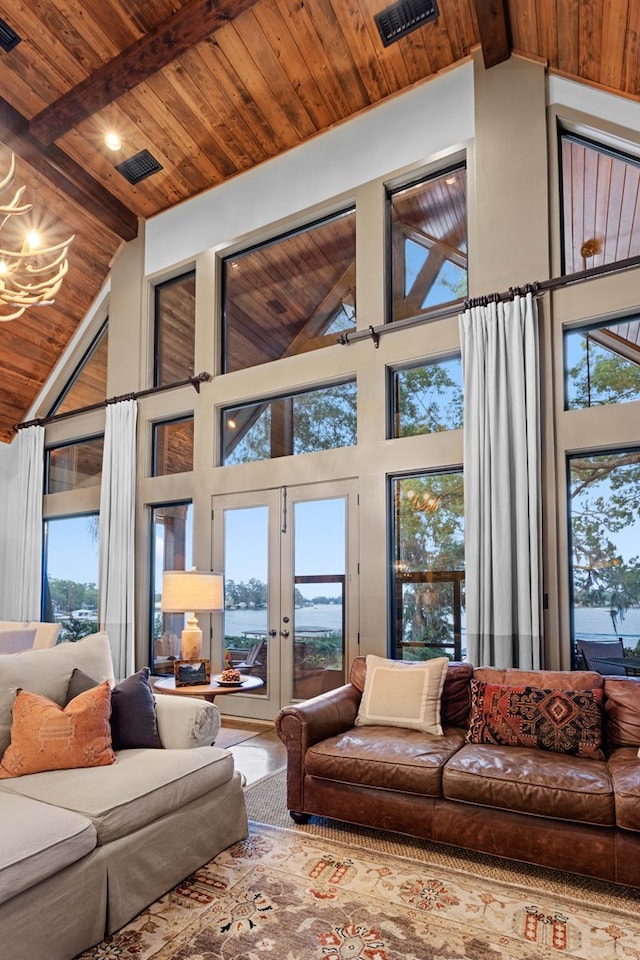 living room with french doors, beamed ceiling, high vaulted ceiling, and wooden ceiling