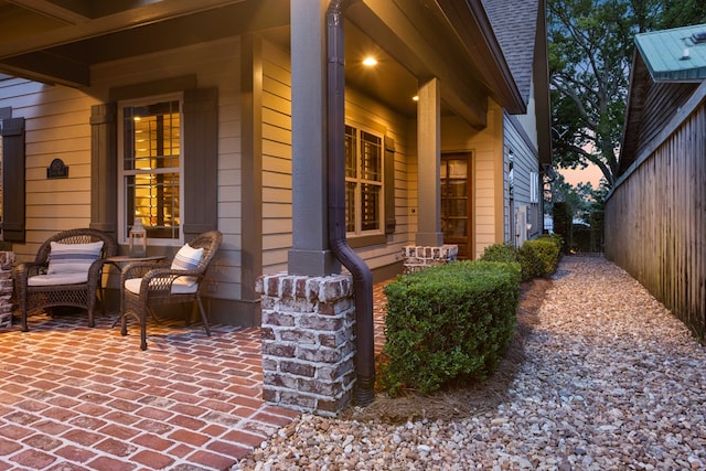 property exterior at dusk with a patio